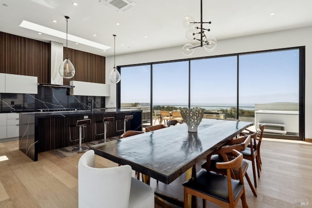 dining space featuring recessed lighting, visible vents, and light wood-type flooring