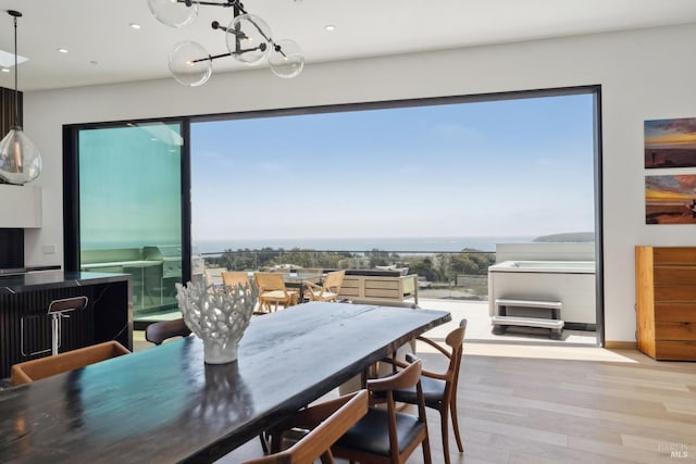dining space featuring recessed lighting, a chandelier, and wood finished floors