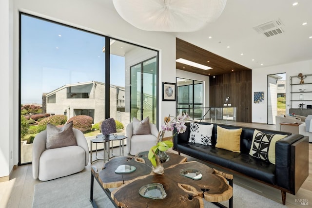 living room featuring visible vents, recessed lighting, and wood finished floors