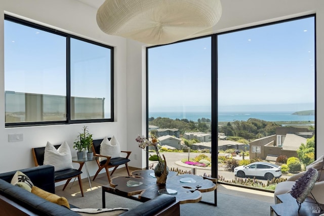 living area featuring a water view and wood finished floors