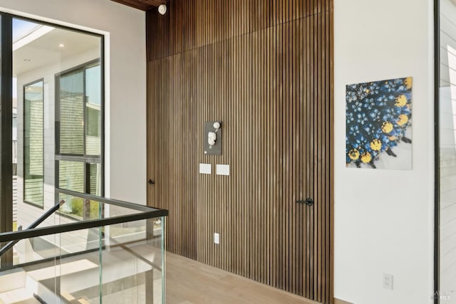 interior space featuring wood walls, a wealth of natural light, and wood finished floors