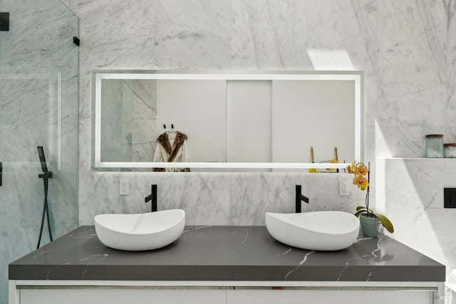 full bath with double vanity, a sink, and backsplash