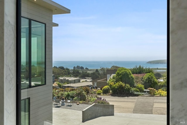 entryway with plenty of natural light and a water view