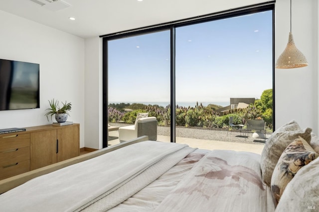 bedroom featuring recessed lighting and expansive windows