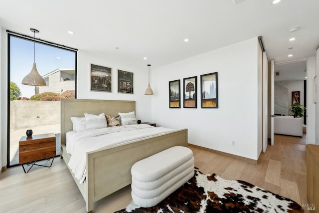 bedroom featuring baseboards, recessed lighting, and light wood-style flooring