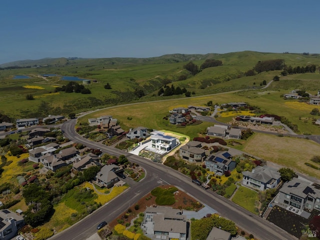 drone / aerial view with a water view and a residential view
