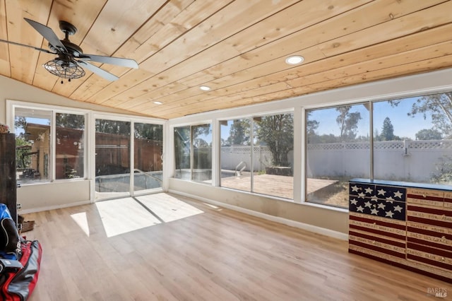 unfurnished sunroom with vaulted ceiling and a ceiling fan