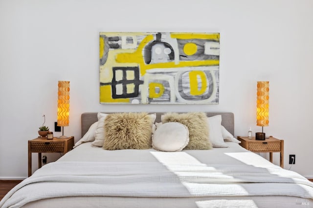 bedroom featuring baseboards and wood finished floors