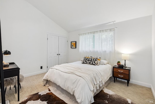 carpeted bedroom with baseboards, high vaulted ceiling, and a closet