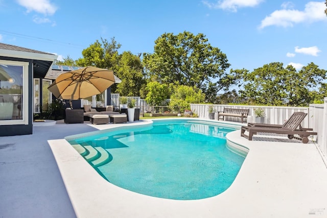 view of swimming pool with a fenced in pool, fence, a patio area, and outdoor lounge area