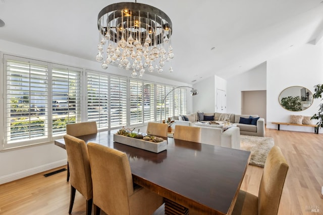 dining area featuring plenty of natural light, lofted ceiling, visible vents, and an inviting chandelier