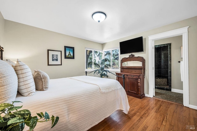 bedroom featuring baseboards and wood finished floors
