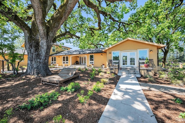 view of front of property featuring stucco siding and french doors