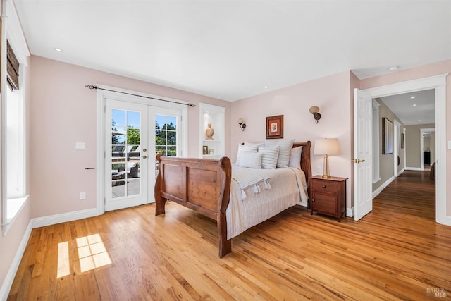 bedroom with light wood-style floors, baseboards, french doors, and access to exterior