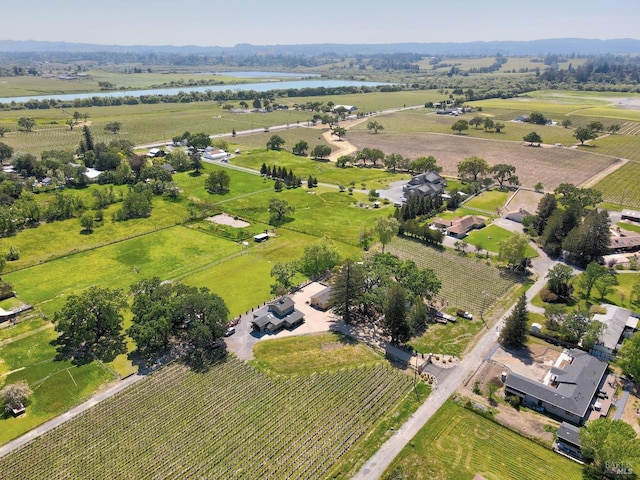 birds eye view of property with a water view and a rural view