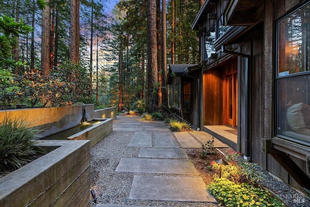 yard at dusk with a patio area