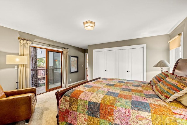 bedroom with a closet, multiple windows, carpet flooring, and access to exterior