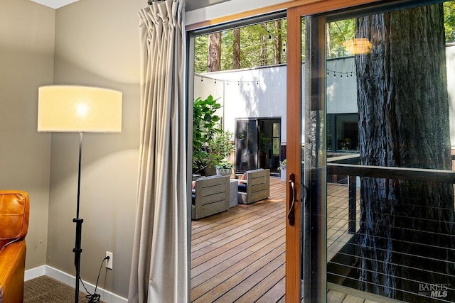 doorway to outside with baseboards and plenty of natural light