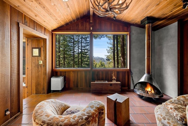 sunroom / solarium with a healthy amount of sunlight and a wood stove