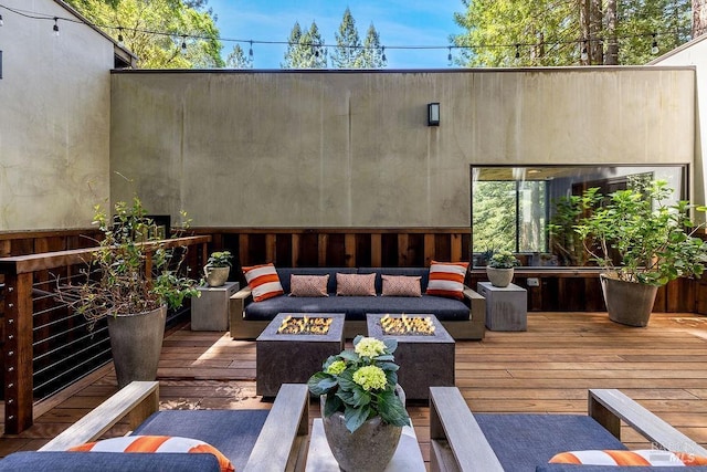 exterior space featuring an outdoor living space with a fire pit