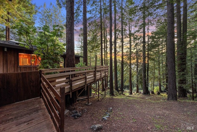 yard at dusk featuring a deck