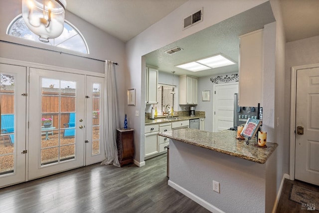 kitchen with french doors, dark wood-style floors, white cabinetry, and visible vents