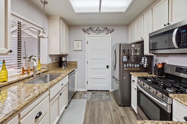 790 Morissette Way, Vacaville, CA 95687 - kitchen featuring appliances with stainless steel finishes, a sink, light wood-type flooring, and white cabinetry
