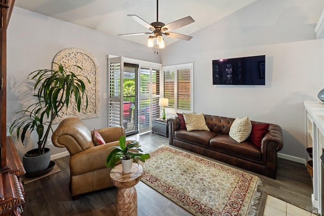 living room with baseboards, a ceiling fan, vaulted ceiling, and wood finished floors
