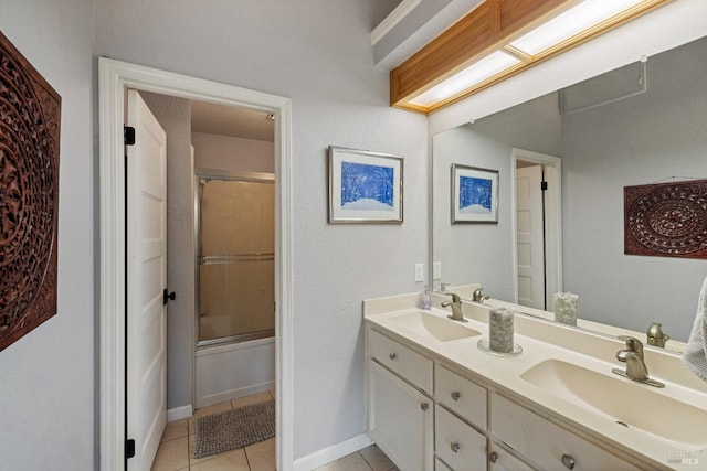 bathroom featuring a sink, tile patterned floors, enclosed tub / shower combo, and double vanity