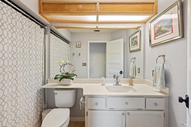 bathroom with vanity, a shower with shower curtain, and toilet