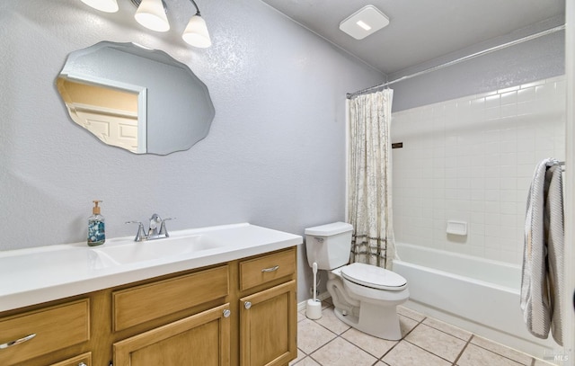 bathroom with tile patterned flooring, toilet, vanity, shower / tub combo with curtain, and a textured wall