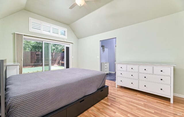 bedroom featuring lofted ceiling, access to outside, light wood-style flooring, ceiling fan, and a walk in closet