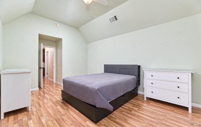 bedroom with light wood-type flooring, vaulted ceiling, baseboards, and ceiling fan