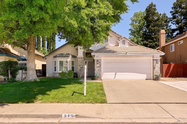 view of front of house featuring an attached garage, stone siding, concrete driveway, stucco siding, and a tile roof
