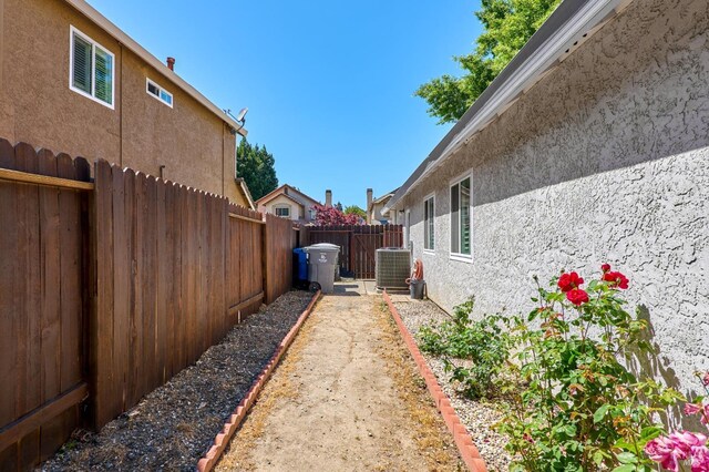 fenced backyard featuring central air condition unit