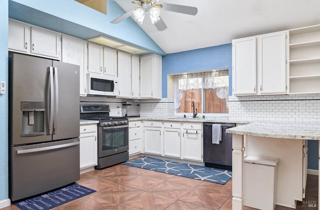 kitchen with stainless steel appliances, ceiling fan, tasteful backsplash, light stone countertops, and open shelves