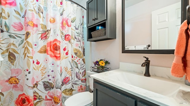 bathroom featuring vanity, a shower with shower curtain, and toilet