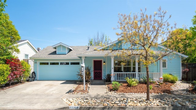 ranch-style house featuring a porch, driveway, roof with shingles, fence, and an attached garage
