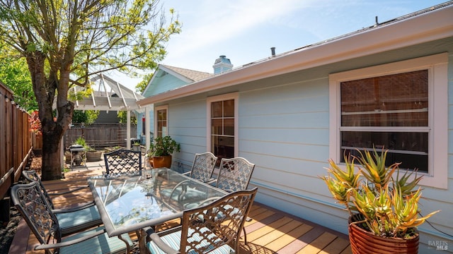 wooden deck with fence and outdoor dining area