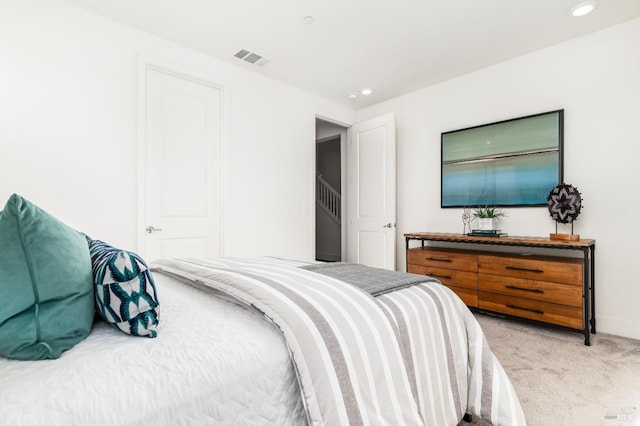 bedroom featuring light colored carpet, recessed lighting, baseboards, and visible vents