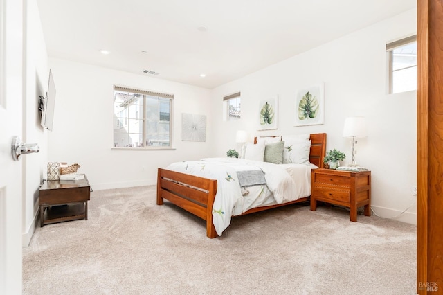 bedroom with baseboards, recessed lighting, visible vents, and light carpet