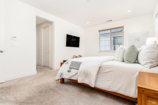 bedroom featuring baseboards, light colored carpet, recessed lighting, and visible vents