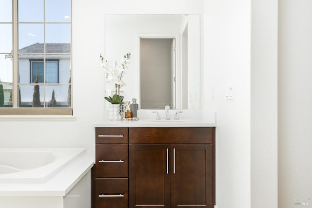 full bath featuring vanity and a bath