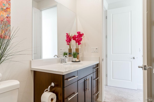 bathroom featuring toilet and vanity