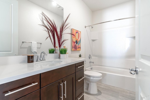 bathroom featuring shower / bath combination, vanity, and toilet