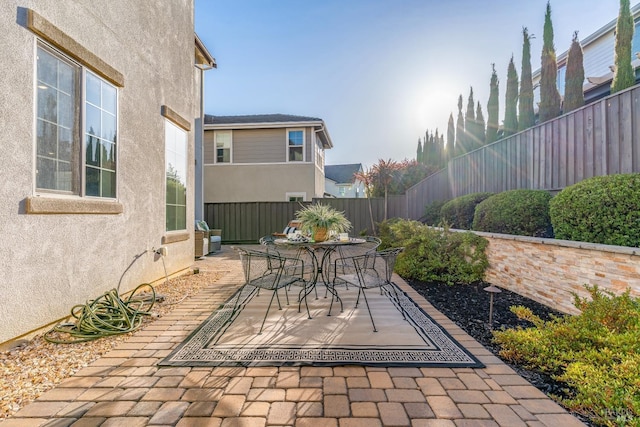 view of patio with a fenced backyard and outdoor dining space