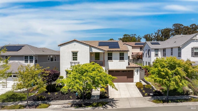 view of front of home featuring a tile roof, a residential view, concrete driveway, an attached garage, and stucco siding
