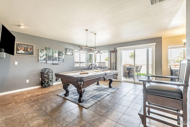recreation room with baseboards, billiards, a textured ceiling, and a wealth of natural light