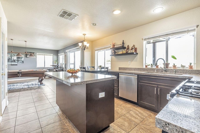 kitchen with dark brown cabinets, a sink, dishwasher, a kitchen island, and visible vents
