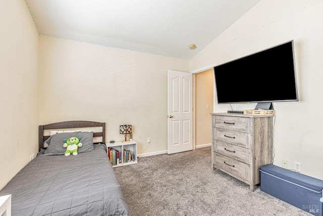bedroom with light colored carpet, baseboards, and vaulted ceiling